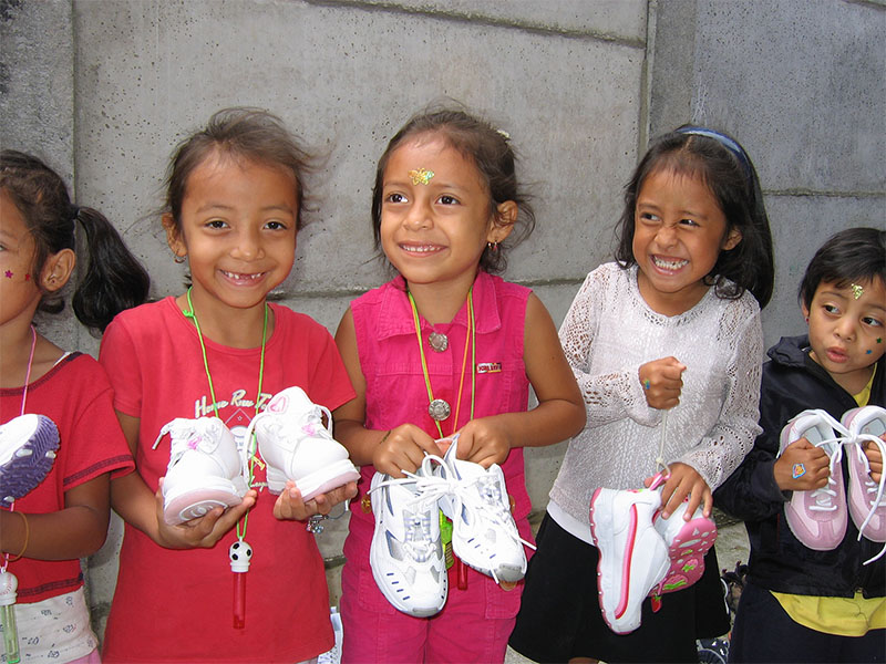 Peruvian children holding new shoes