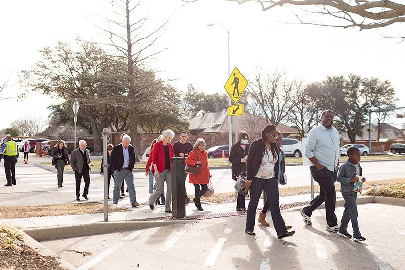 people walking across the street