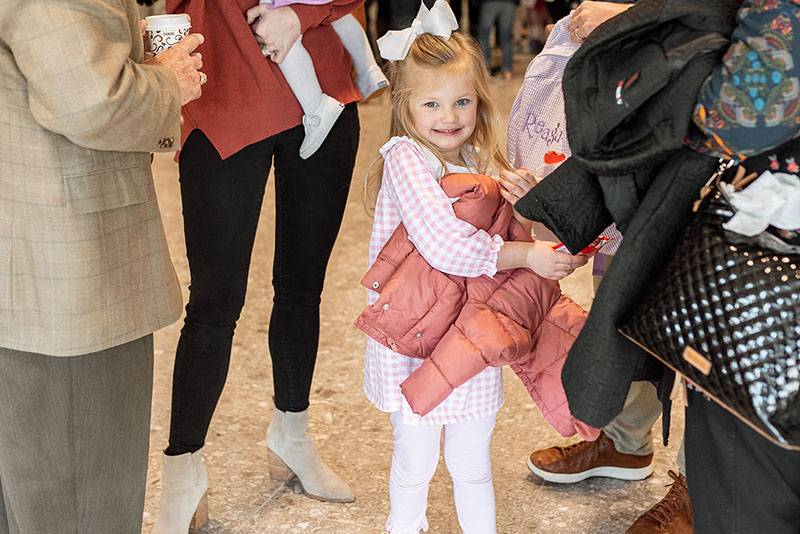 smiling girl holding coat